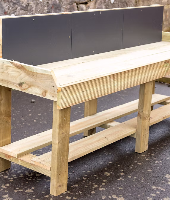 Timber play structure in a spacious outdoor setting